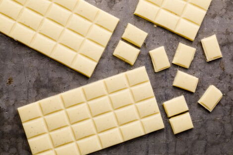 Bars of white chocolate on a table.