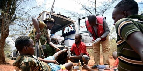 A file photo of Red Cross officers and police officers giving first aid to an injured victim of an attack at Kapindasum area in Baringo south by suspected Pokot bandits.