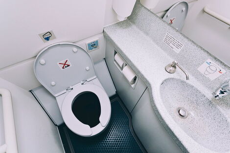 A photo of toilet inside a plane 