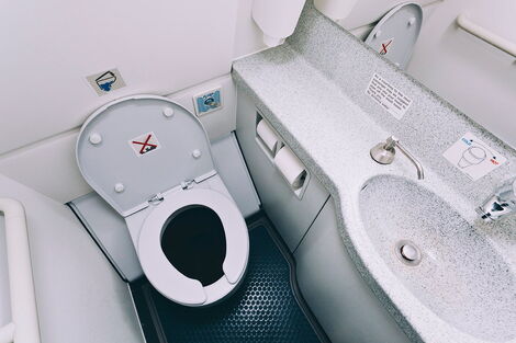 A photo of a toilet inside an airplane