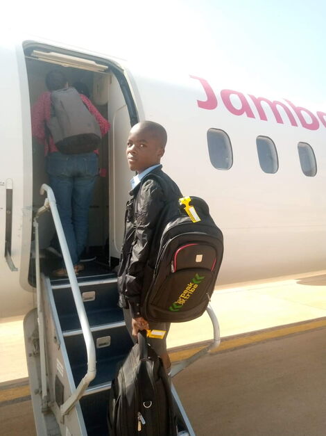 Robinson Fwaro Makokha boarding plane as he heads to Alliance High School for form one admission on Monday, February, 6,2023
