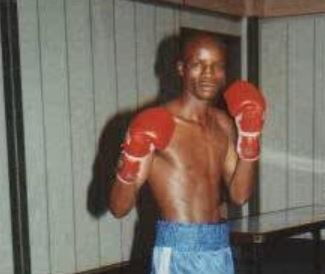 Retired professional boxer John Gicharu poses for a photo.