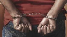 Undated file image of a suspect in handcuffs after being arrested