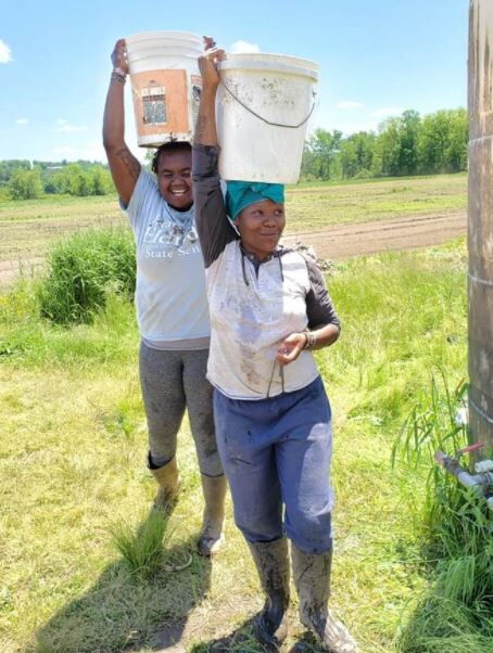 Henrietta Isaboke (back) on her farm in the US