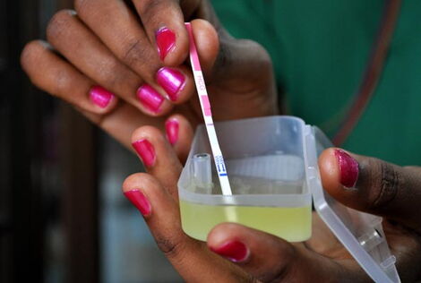 A woman conducting a pregnancy test