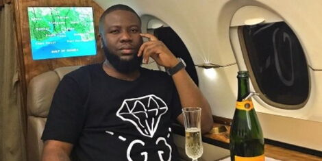 Hushpuppi poses for a photo in a private jet