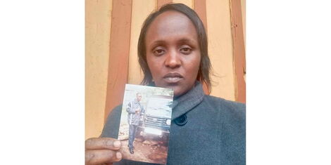 Judy Wambui Mugo with the photo of her husband Harrison Mugo at their home in Maragwa, Murang’a County. 
