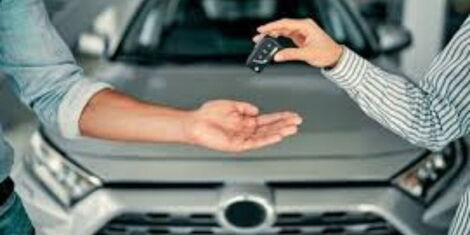 An image of a hand receiving car keys. 