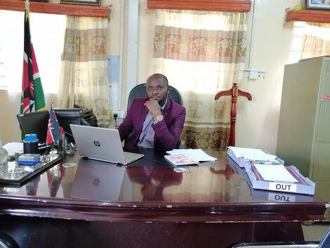 File photo of Godfrey Kimutai Tanui seated at a desk in an office