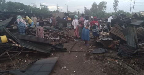 Traders at Pap Mbuta watch as their structures are demolished on Friday, January 8, 2021.