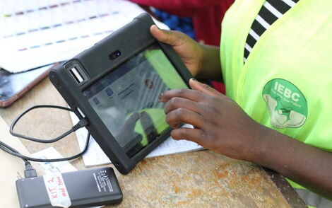 An image of an IEBC official using the KIEMS kit at a past election.