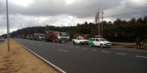 A convoy of trucks with abnormal loads on the road