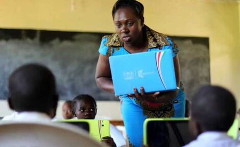 A teacher at Butere Primary School in Kakamega County introduces her pupils to digital tablets on May 3, 2016