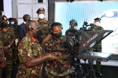 Chief of Defence Forces (CDF) General Robert Kibochi holding a camera during the launch of the KDF studios in Nairobi on November 2, 2021.