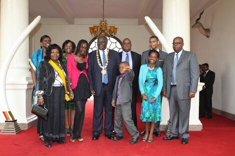 The late President Mwai Kibaki together with the late First lady Lucy Kibaki posing for a family photo at State House Nairobi at a past event.