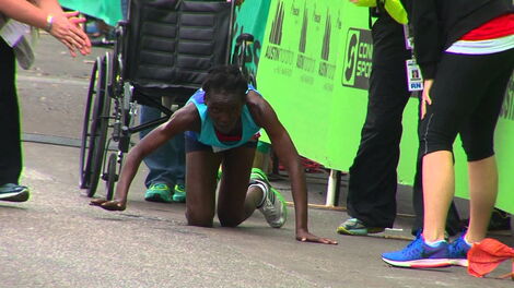 Hyvon Ngetich crawls during the Austin Marathon held on February 15, 2015 