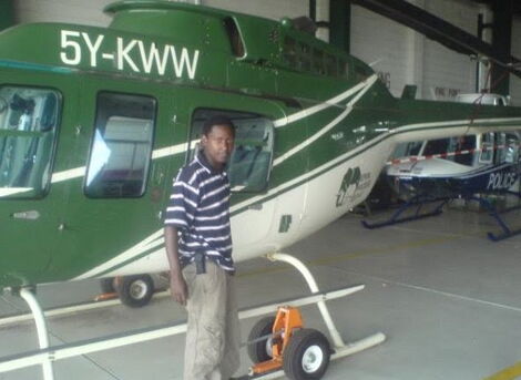Photo of Evans standing next to KWS helicopter. 