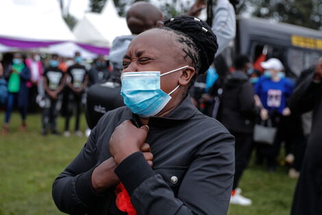 Catherine Wawira, the mother of the slain brothers, overwhelmed by emotions during the burial on Friday, August 13.