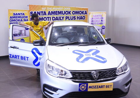 University of Nairobi law student Erick Martin Wafula poses in his car after winning Mozzart Bet’s Omoka Na Moti’s promotion on Friday, December 31