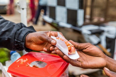 Smokie vendor selling to a customer