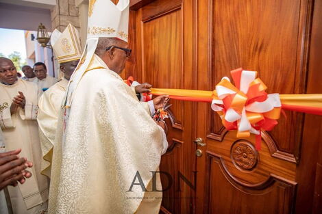 Retired Archbishop John Cardinal Njue cuts a ribbon to launch a residence constructed to house retired clerics. 