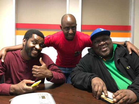 Njoro (left) and Papa Shirandula (right) with a friend during a previous interview in 2019.