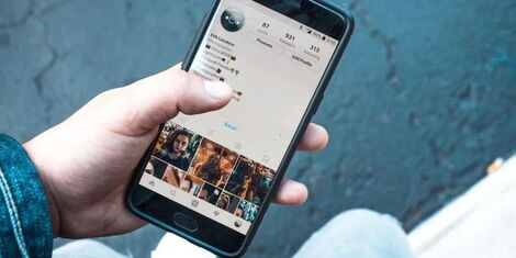An image of an individual holding a phone.