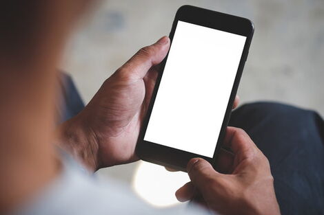 File image of a phone user perusing a gadget.