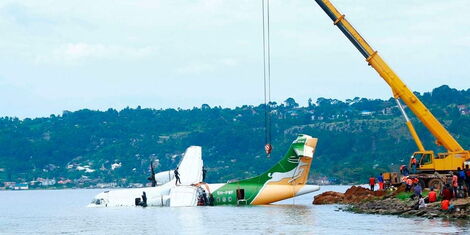 Workers use a crane to pull the crashed Precision Air aircraft out of Lake Victoria in Bukoba, Tanzania, on November 8, 2022, after it crashed on November 6, 2022, while trying to land.