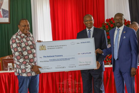 President Uhuru Kenyatta (left) accepting a contribution from CBK governor Patrick Njoroge, on March 20