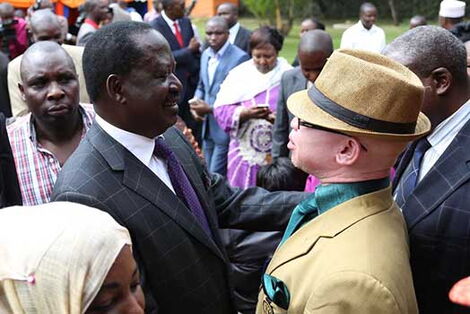 ODM leader Raila Odinga with nominated Senator Isaac Mwaura in 2014.