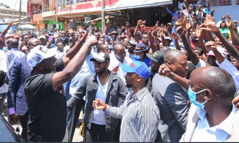 DP William Ruto (in black shirt) with Embakasi West MP George Theuri (in hat) during a public event in March 2021.