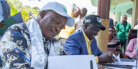 National Assembly Speaker Justin Muturi signing a coalition agreement with Deputy President William Ruto on April 9, 2022.