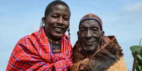 Saloton poses for a photo with a fellow Maasai elder