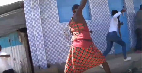 Mbuzi Seller chasing the same character as they act out a scene against a white and blue checked backdrop.