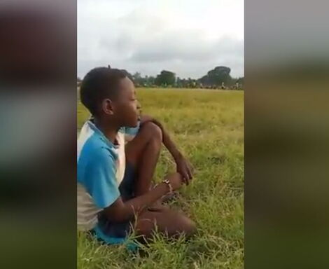 A screenshot of the young boy commentating a football match