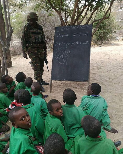 Military officer pictured taking pupils through their lessons, picture undated.