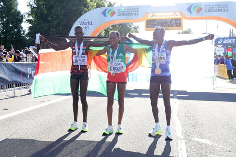 Kenya's Judith Korir (R), Ethiopia's Gotytom Gabreselase (M) and Isreal's Lonah Salpeter (L) celebrating their impressive performances at the 2022 World Athletics Championships in Oregon on July 18.