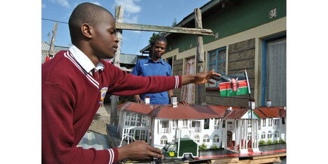 Wellington Otieno, 17, shows off the 'Statehouse' art that he made at their home in Majengo slums on the outskirts of Narok town on May 23,2022