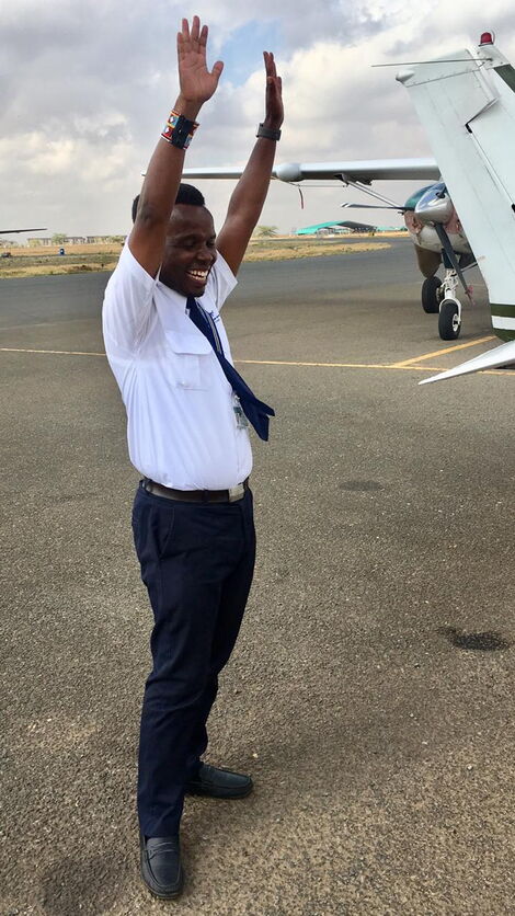 Tim Njiru celebrating after flying solo for the first time in May 2019.