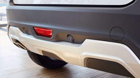 File image of a car's rear showing tow eye covers.