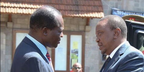 President Uhuru Kenyatta (right) with Jubilee Secretary-General Raphael Tuju (left) at the All Saints Cathedral, Nairobi in October 2015
