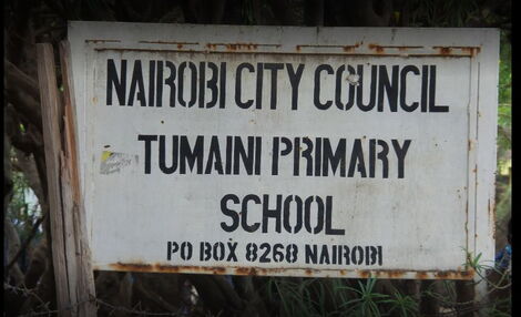 A signpost showing Tumaini primary school