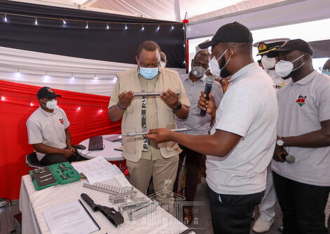 President Uhuru Kenyatta inspecting a gun made in Kenya at the KWS Law Enforcement Academy in Manyani, Taita Taveta County on October 16, 2020