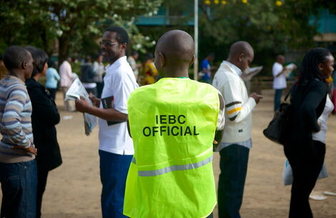 An IEBC official coordinates voters at a polling station in Kenya.