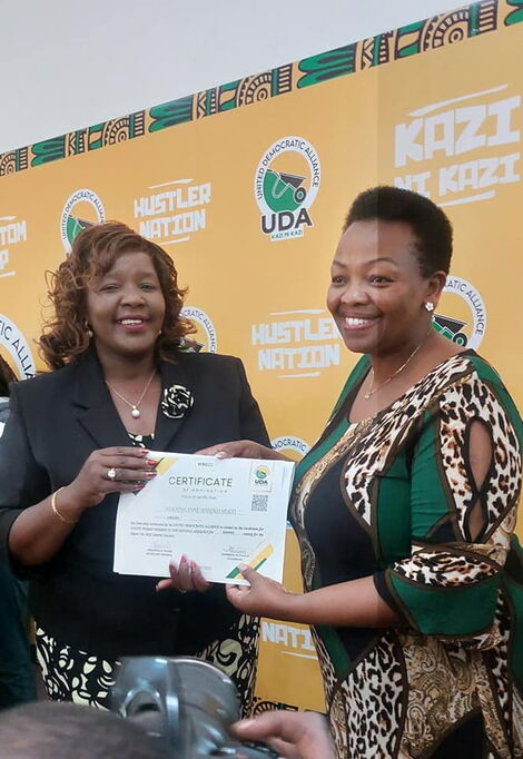  Anne Wamuratha receiving her UDA nomination certificate from the party Secretary General, Veronica Maina.