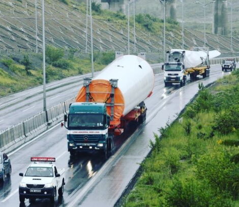 Trucks with wide load on the road.