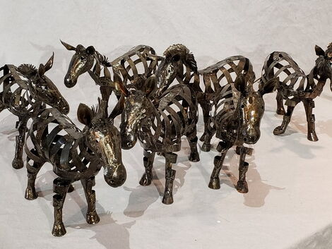 An image of metallic Zebra sculptures made by Samuel Ochanda.