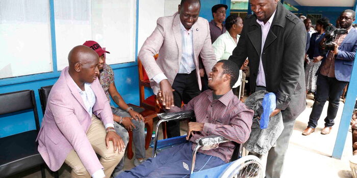 Deputy President William Ruto with a special need student at 
