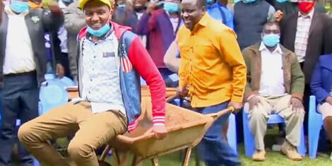 A File Image of Former TSP Deputy Party Secretary General Pushing a Man on a Wheelbarrow